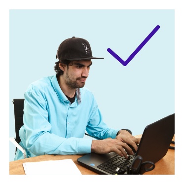 A person typing on a computer and a tick.